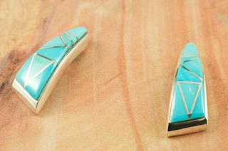 Genuine Sleeping Beauty Turquoise inlaid between ribbons of Sterling Silver. Beautiful Sterling Silver Post Earrings feature precision channel inlay. Designed by Navajo Artist Calvin Begay. Signed by the artist.